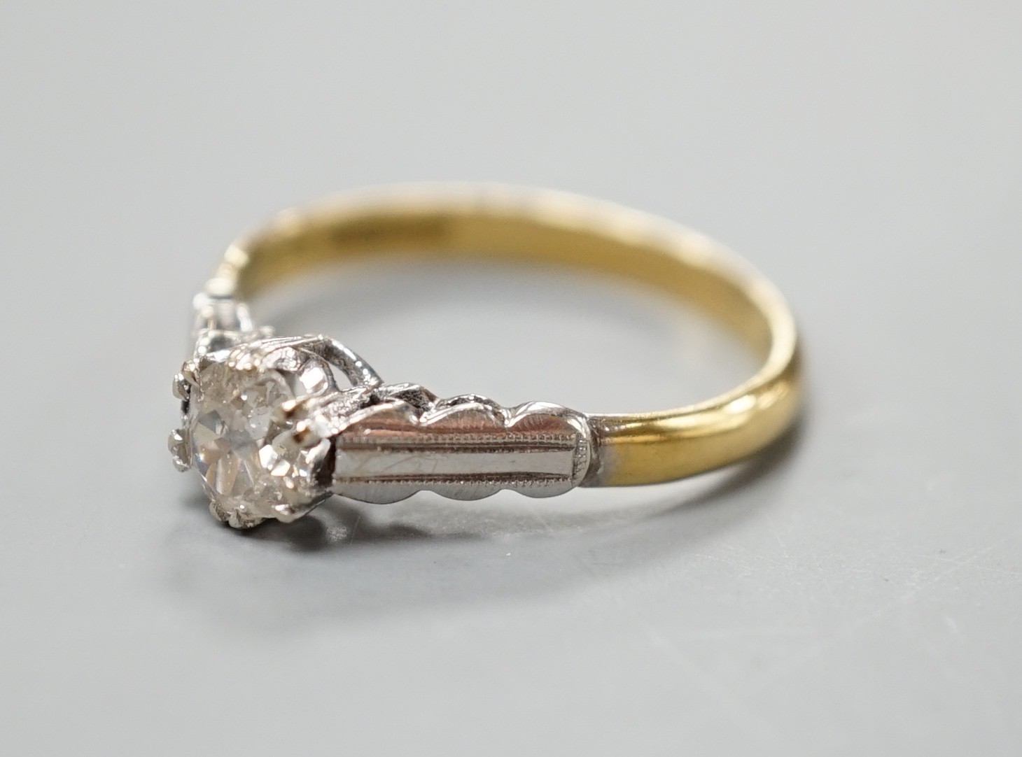 A modern 18ct gold and solitaire diamond ring, size M, gross weight 2.7 grams.